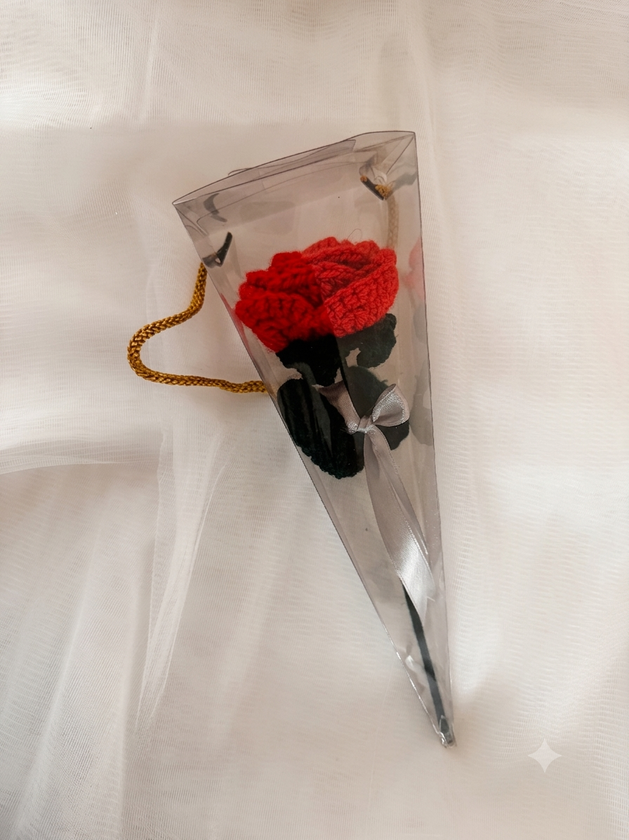 Handcrafted crochet red rose with black stem in clear triangular gift sleeve with gold chain handle