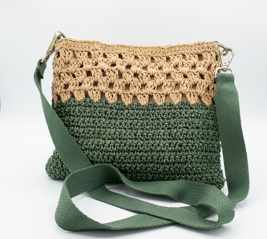 Green and beige two-tone crochet crossbody bag on white background