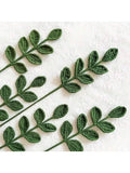 Handcrafted crochet leaf sprigs in forest green yarn