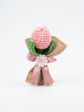 Handcrafted crochet blush pink tulip bud with green leaves in burlap wrap tied with dusty rose satin ribbon bow and white daisy charm