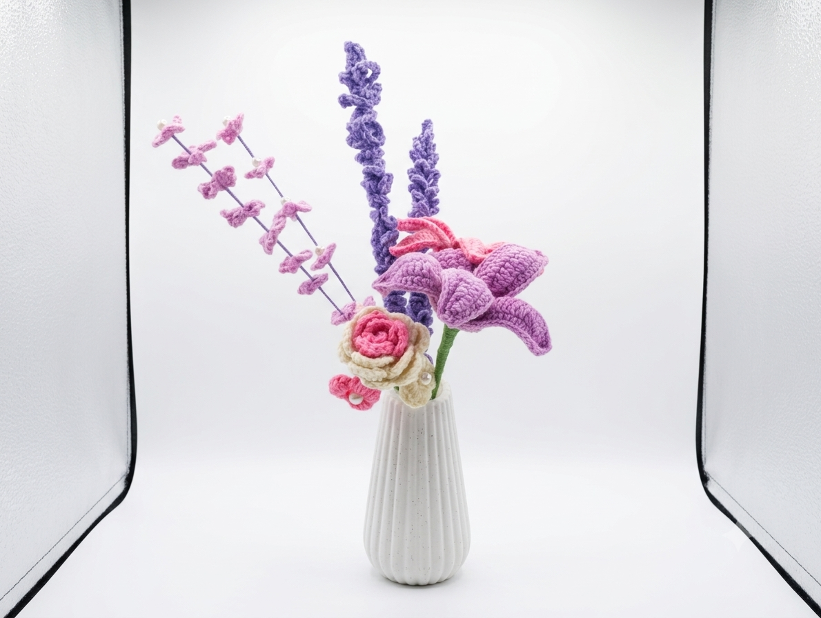 Handcrafted crochet bouquet with pink and purple flowers in white ribbed vase, studio shot